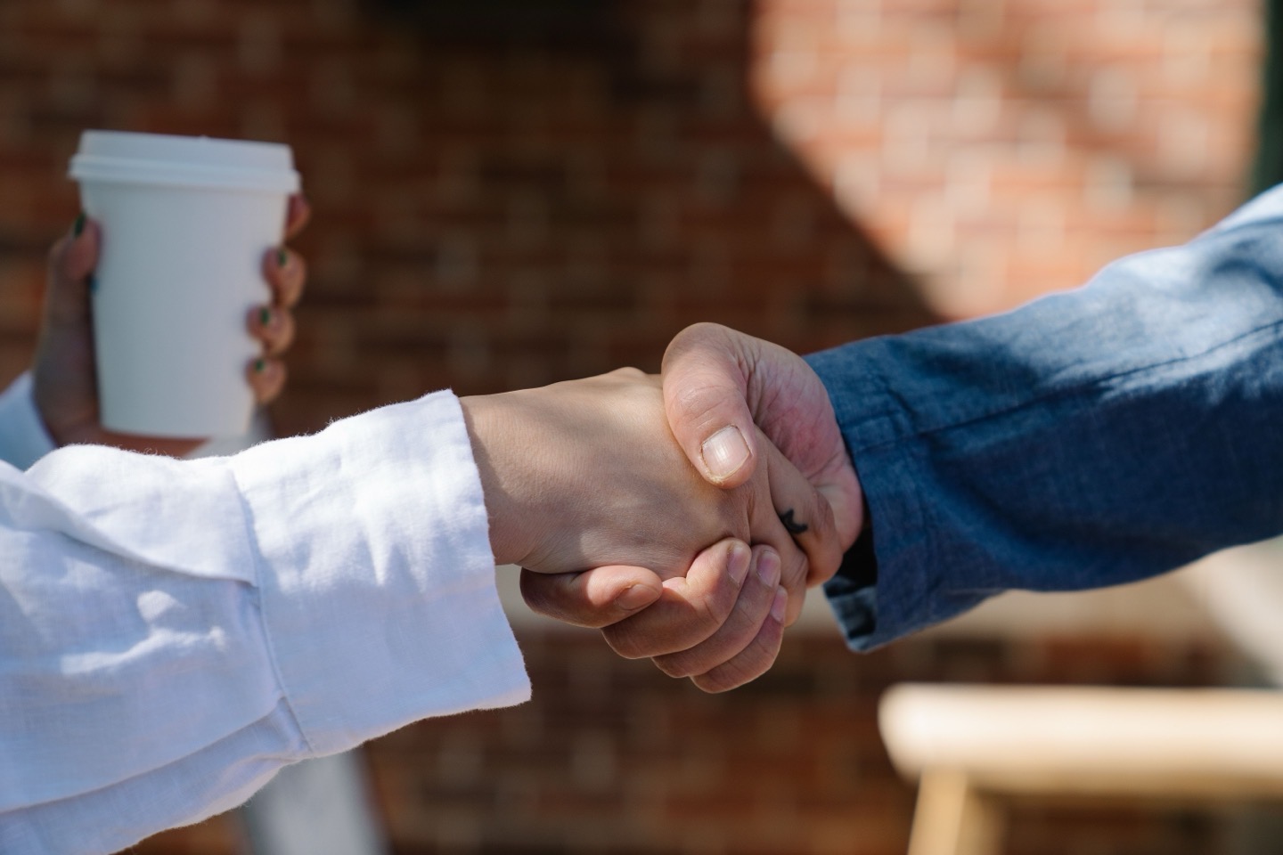 Local business owner shaking hands with a customer, representing trust