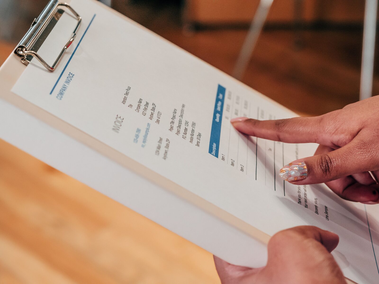 Close-up of a company invoice on a clipboard, representing website project pricing